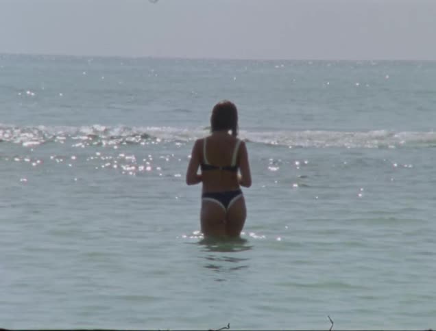 Woman in bikini goes swimming