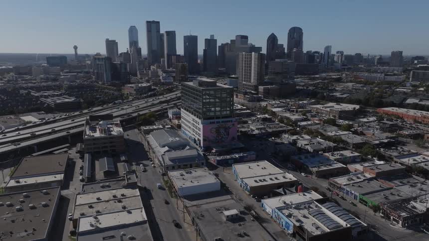 Aerial of a highway running through an urban area on a clear sunny day