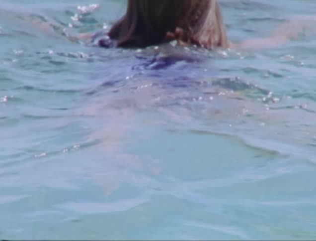 A woman swimming and diving in the ocean
