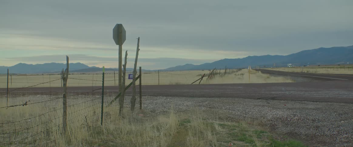 A rural region with asphalt streets and fields of dry grass