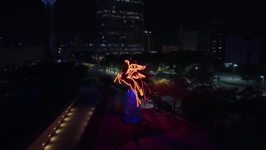 A tower decorated with colorful lights in the city at night