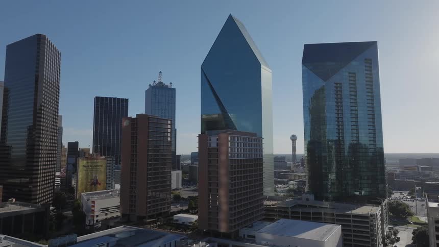 A place with several huge buildings with reflective mirrors in their structure