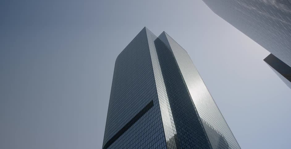 A tall building is reflecting the sun on a clear day