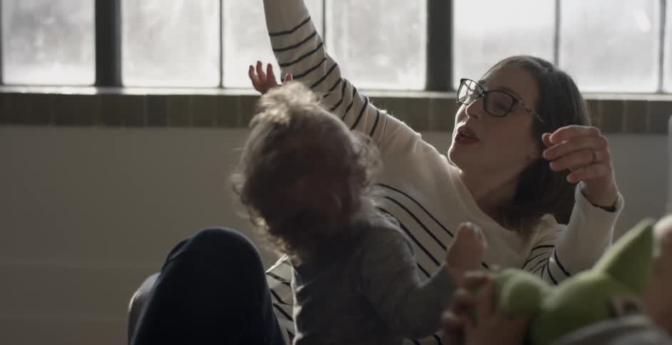 Children plays with toys and their mother
