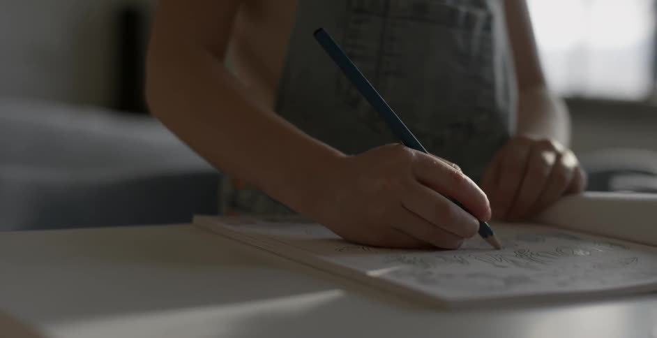 A child is drawing in a book