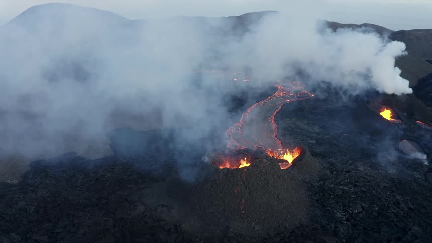 Volcano erupting surrounded in smoke outdoors during day time