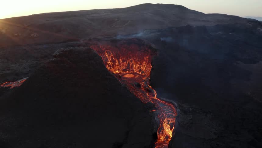 Aerial view of lava flowing out of an active volcano
