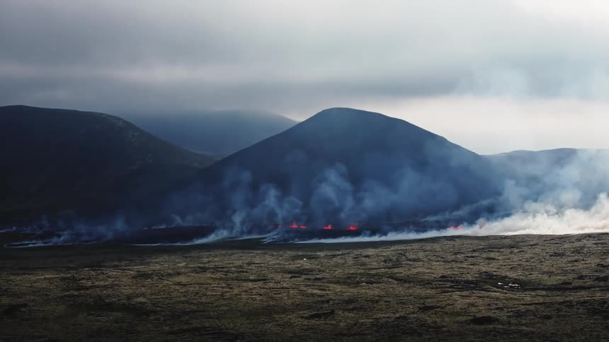 Aerial view of smoke rising from a field