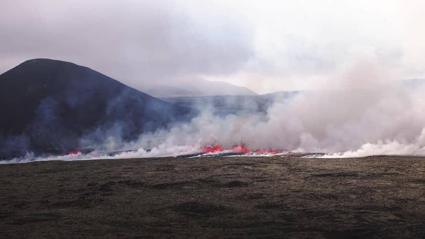 Lava and smoke on a volcanic area after an eruption during day time