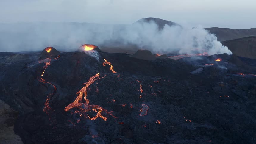 Aerial of an erupting volcano during dusk