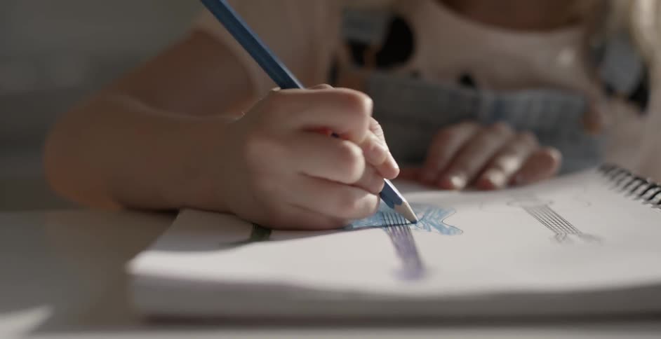 A girl is coloring in a book