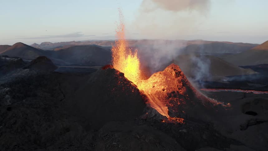A small volcano is erupting and spewing lava upwards