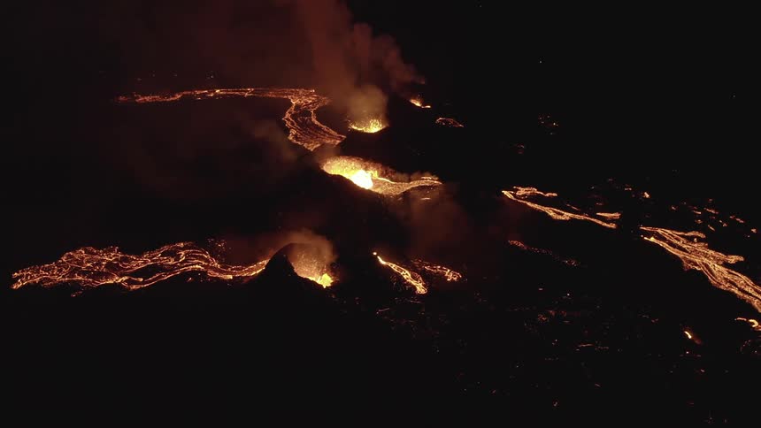 Aerial of a volcano erupting at night