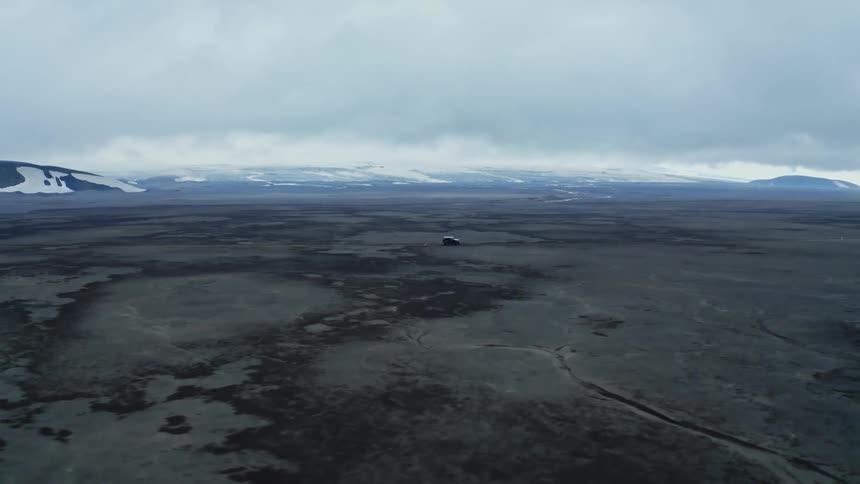 Aerial view of black jeep driving in the desert