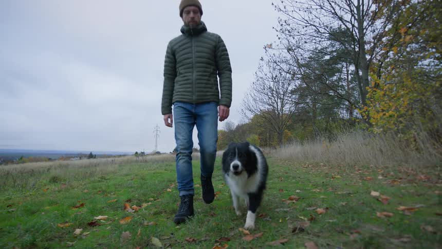 Man walks with his dog in the countryside