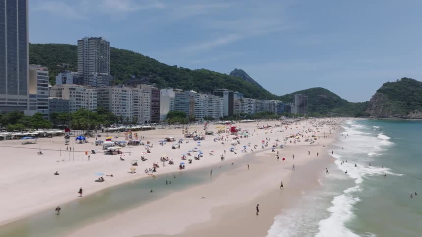 People enjoying a day at the ocean beach in a touristic location