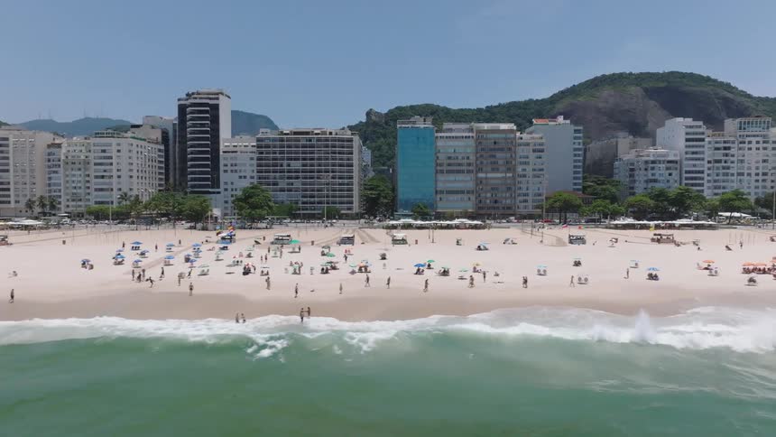 Aerial of vacationers on the beach in a resort area on a sunny day
