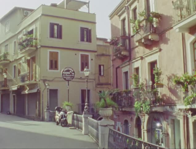 Footage of buildings in a city is displayed in spring
