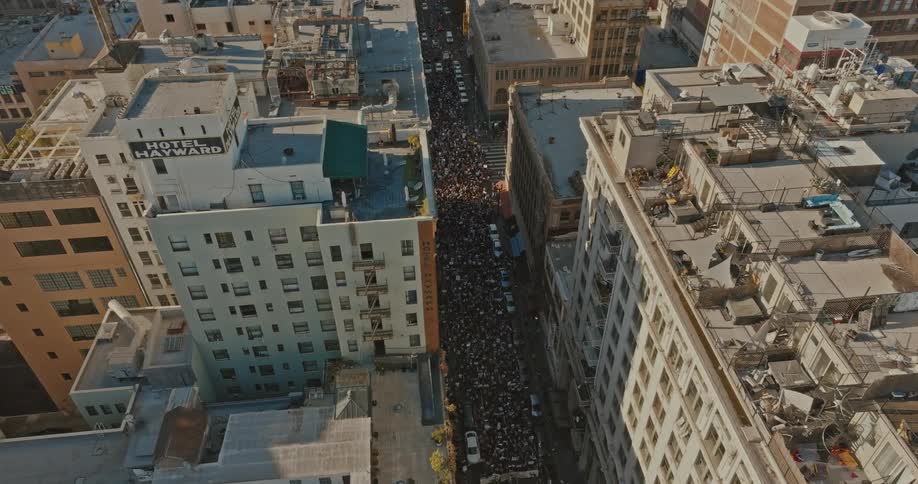 Aerial panorama of crowds of people with signs demonstrating on the streets of the city