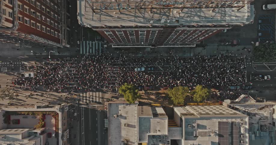 A crowd marched through the city during the sunny afternoon