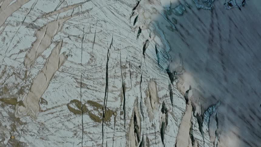 Mountain with cracks covered in ice during the day