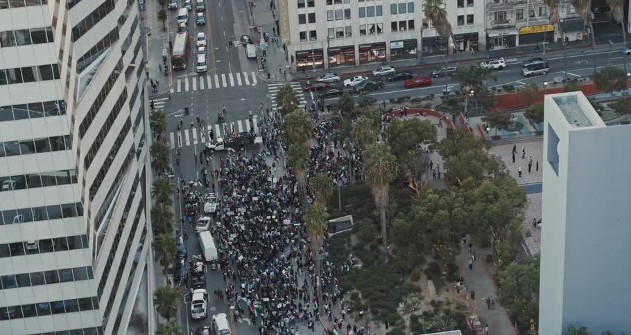 An aerial view of a city street with a crowd of people