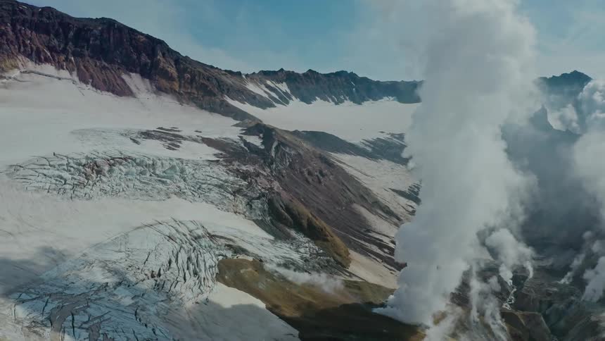 Steam rises from the geyser on the mountain