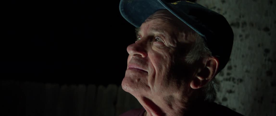 An elderly man observing the night sky