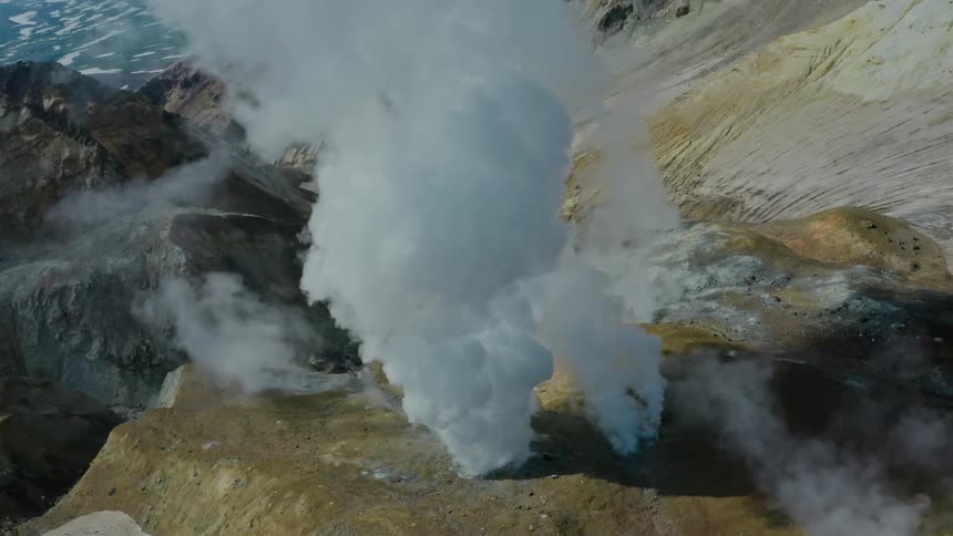 Smoke rising from holes in mountain soils
