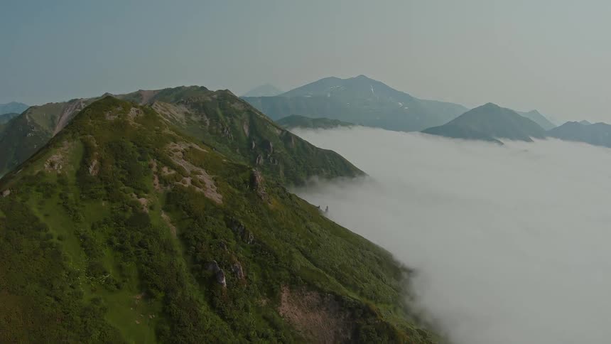 Aerial panorama of peaks and mountains surrounded by clouds