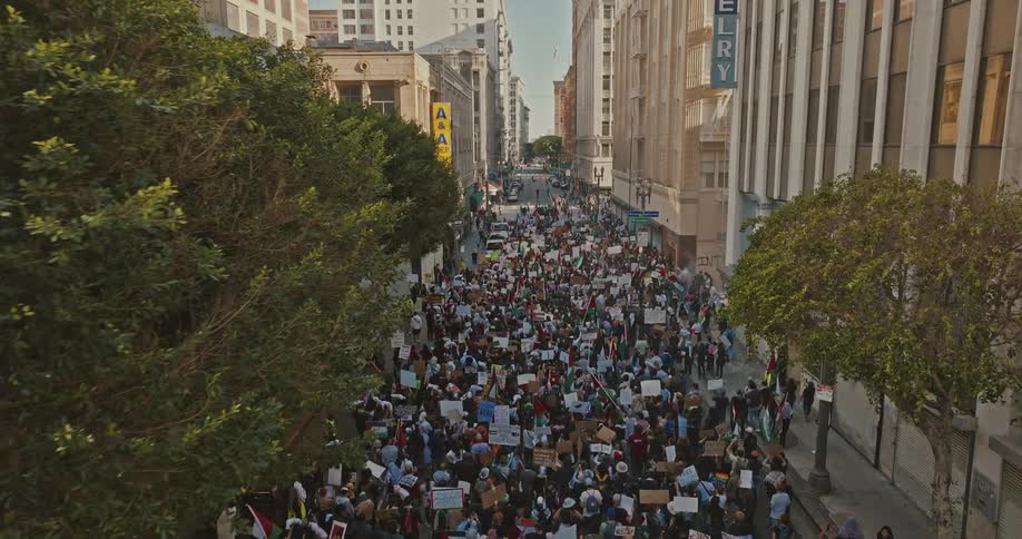 Crowd of people protesting in the streets of a city