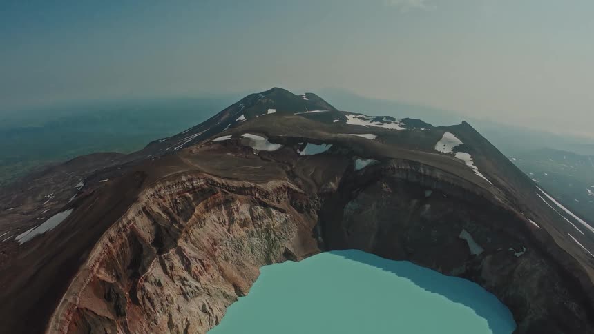 Aerial panorama of mountains with a blue lake on their surface