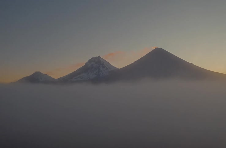 View of mountains and peaks above the clouds in the morning