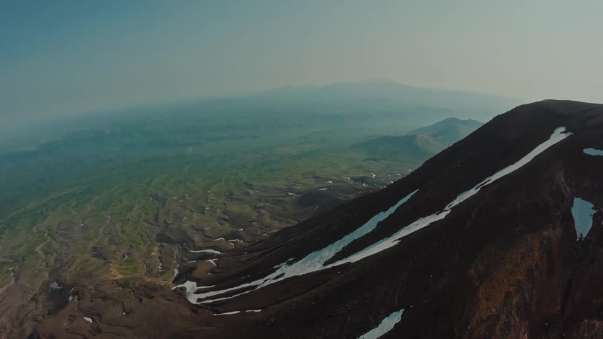 Aerial panorama of mountains and peaks with snow in the daylight