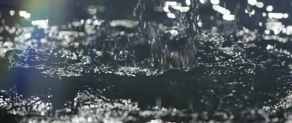 Palm of a hand being slapped on the water generating impact in slow motion
