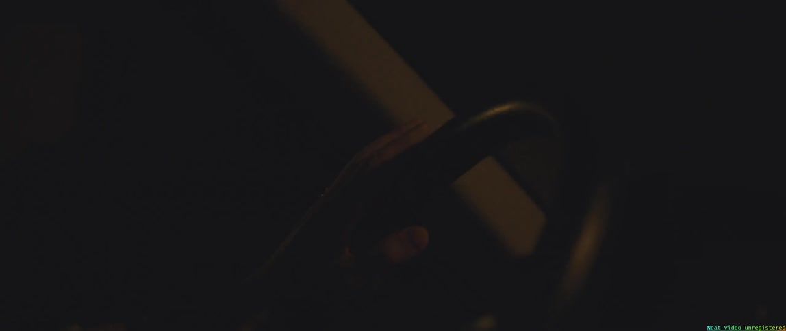 Womans hand on the steering wheel driving at night