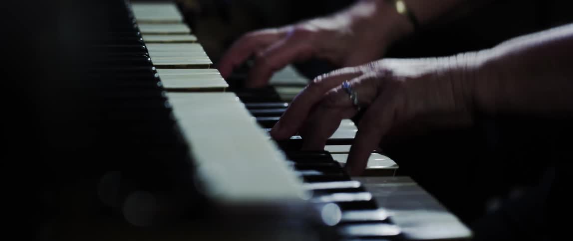 Close up of a man playing the organ