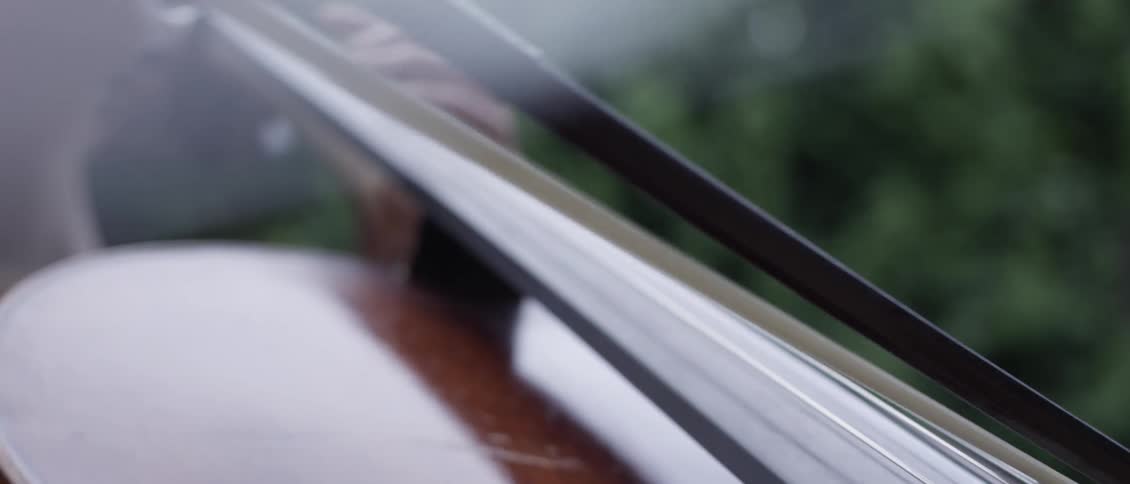 Closeup of a womans hands playing the violin