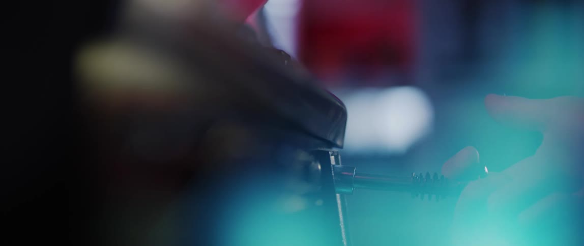 Person pulls plunger on pinball machine to start a game