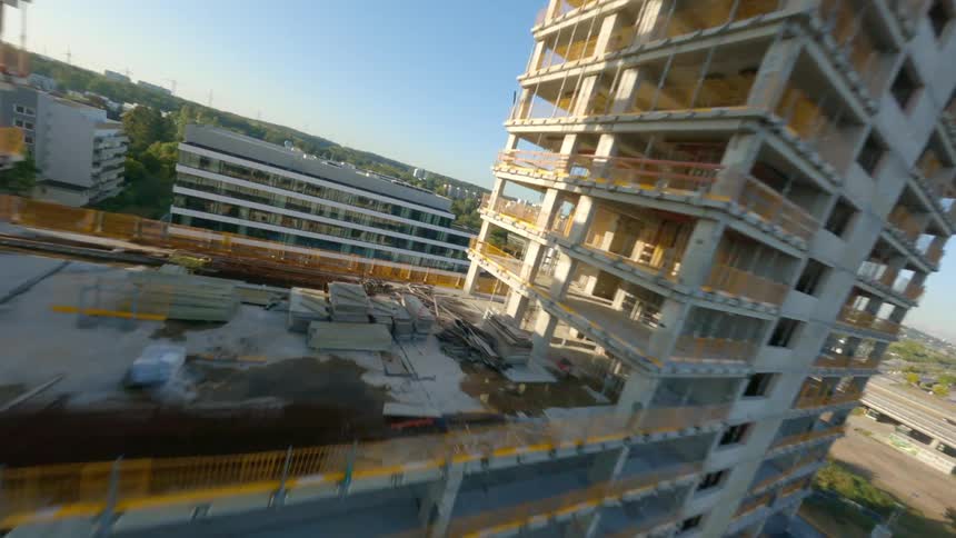 A drone flying across a building under construction
