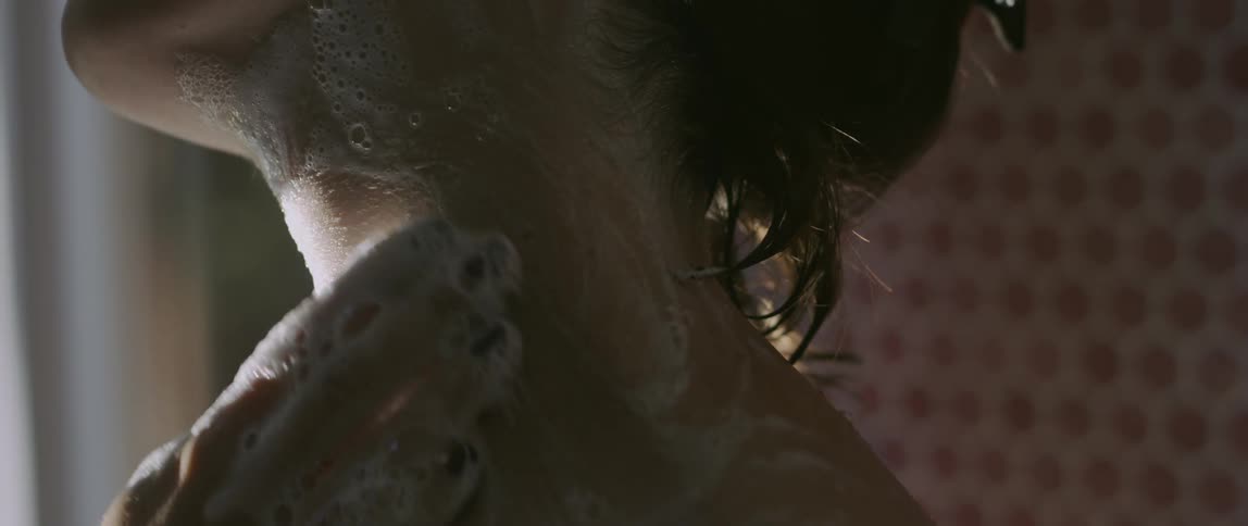 Woman washing her neck and massaging it with foam