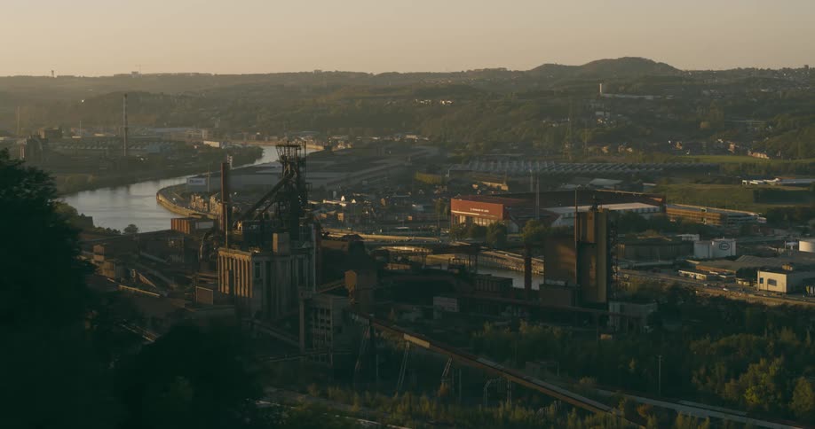 A manufacturing plant is over the river by the town