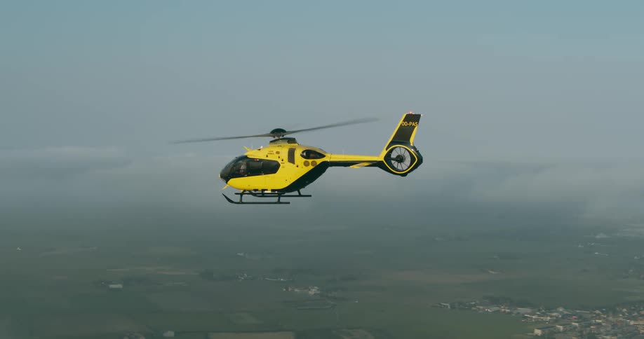 Aerial of a helicopter flying over a cloudy landscape