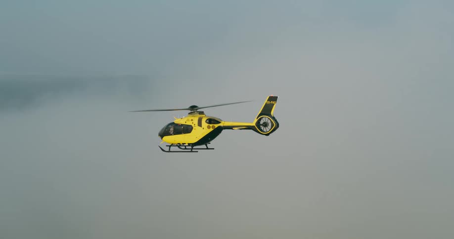 The helicopter is flying through the clouds