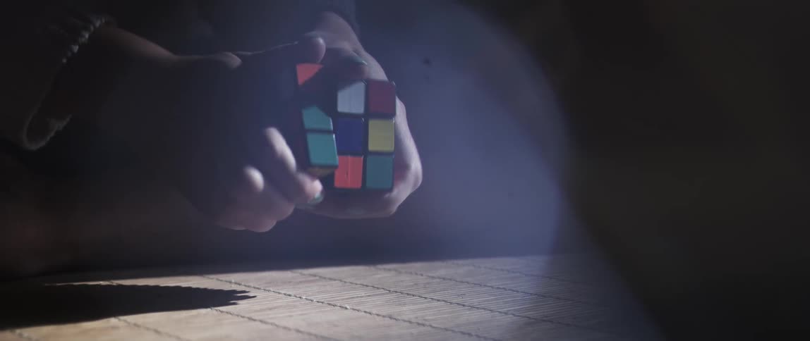 A person playing with a rubiks cube