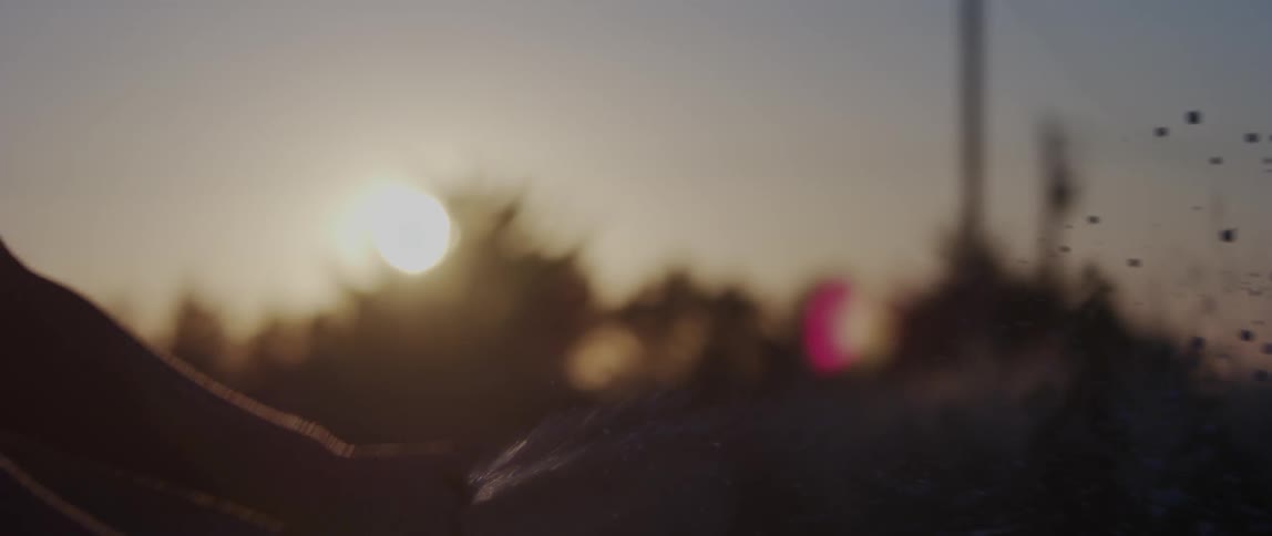 Hands of a man popping wine outdoor at sunset