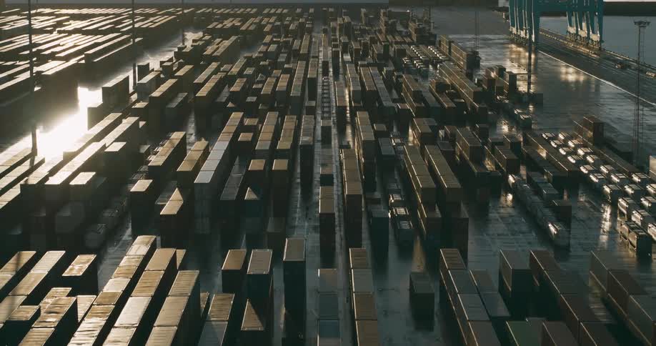 Port with shipping containers and the sunrise reflecting on the water