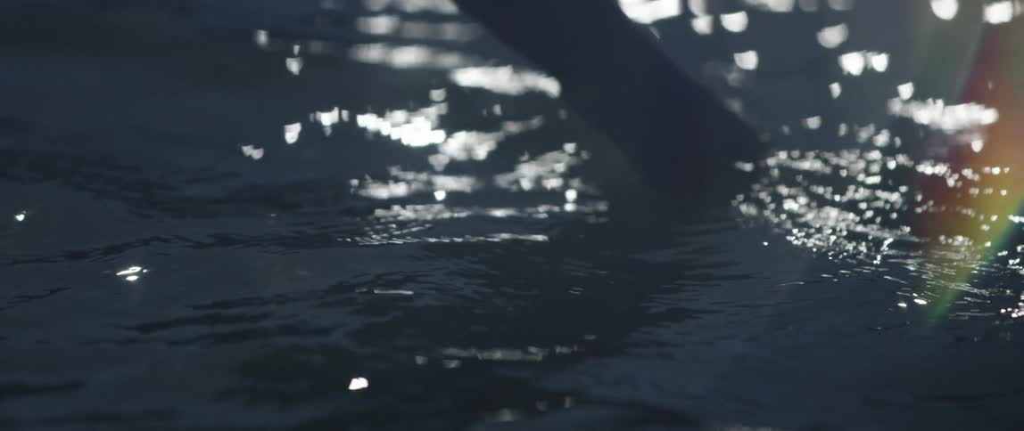 Someone gently dipping their hand into seawater
