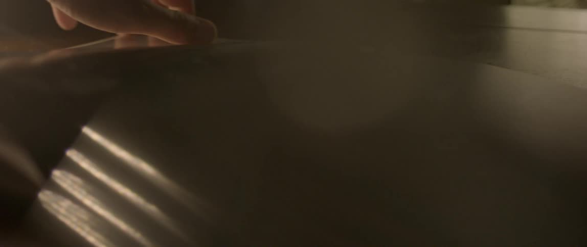 Closeup of a persons hands flipping through pages of an album