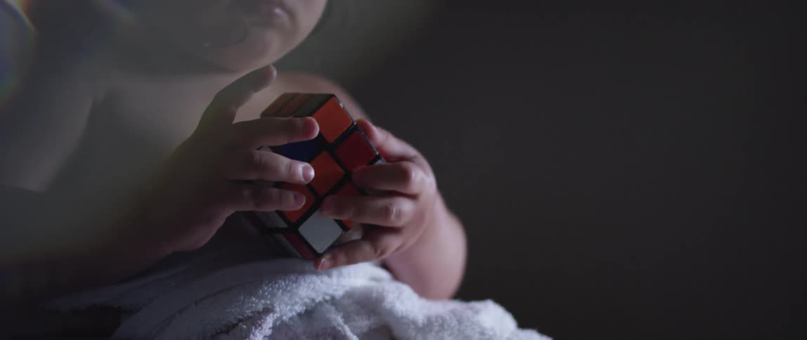 Small child holding a rubiks cube